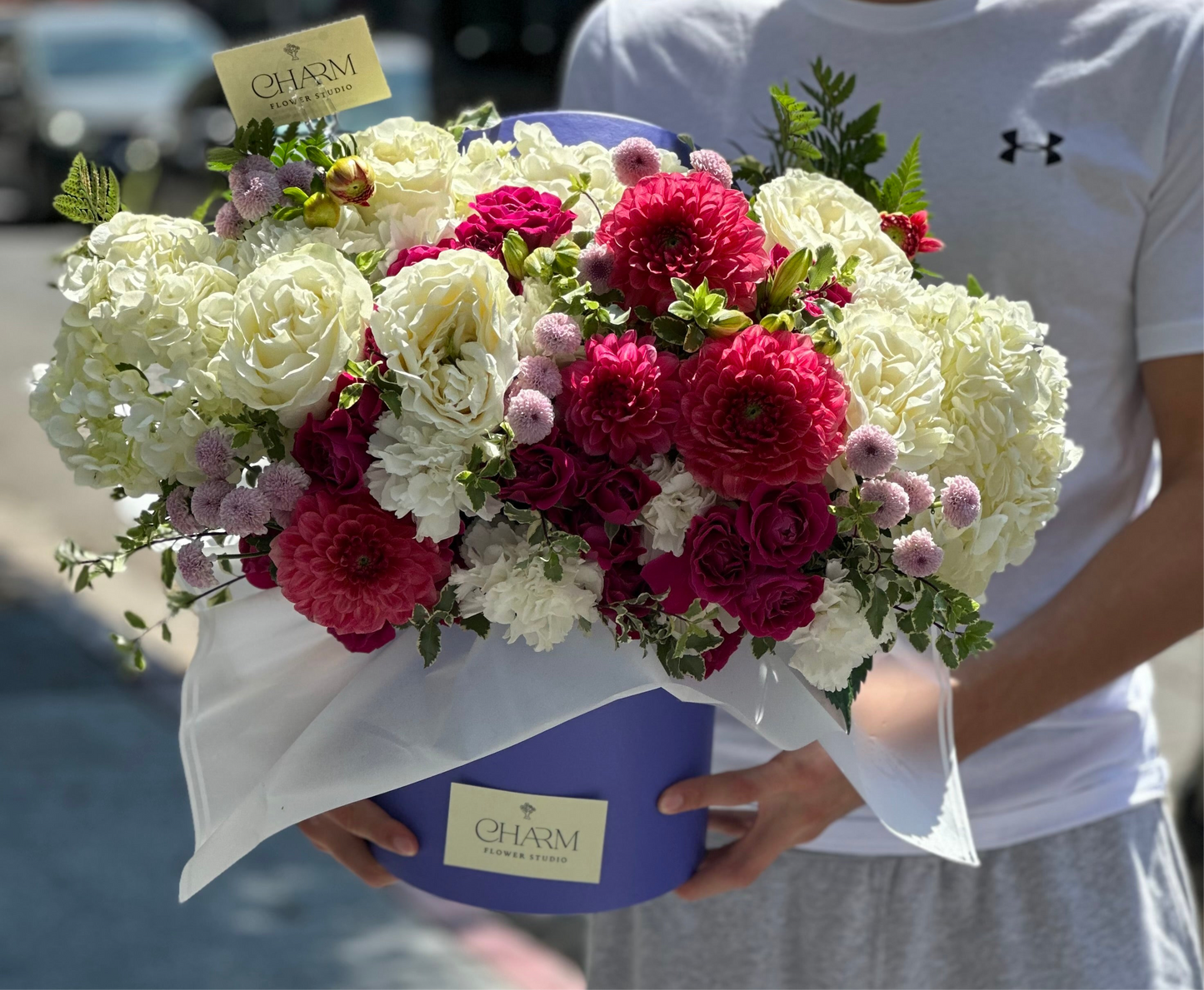 Bold magenta and white flower arrangement in royal blue hat box — Charm Flower Studio floral gift for special occasions